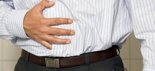 man with hand on stomach