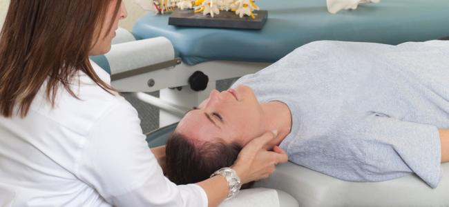 woman recieving neck adjusment from chiropractor