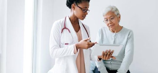 older woman speaking with doctor