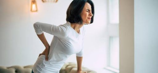 woman bent over with back pain