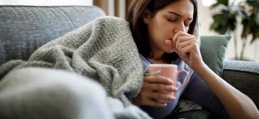 girl coughing on couch