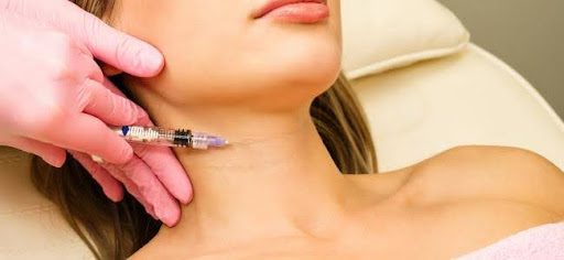 woman getting an injection in her neck