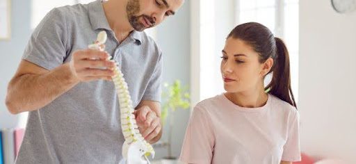 doctor showing spine to patient