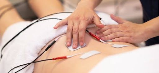 placing electrodes on persons back