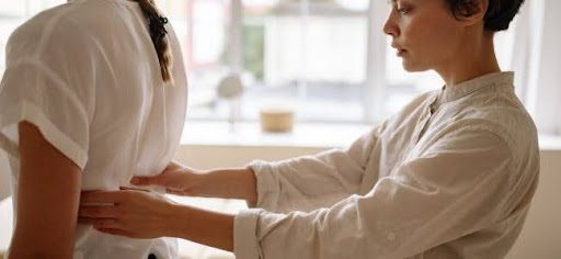 woman treating patient back