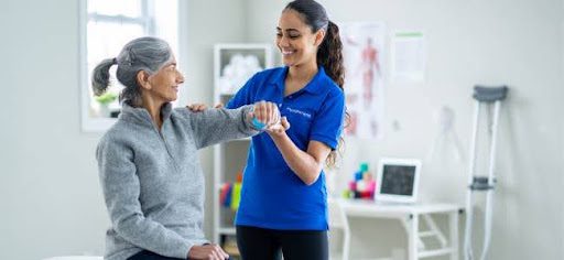 nurse helping older woman stand