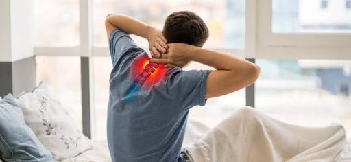 man with upper spine pain