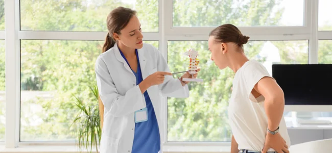 How Long Does an Epidural Steroid Injection Last? 1 Pain management physician using a spine model to explain an epidural steroid injection to a patient with lower back pain